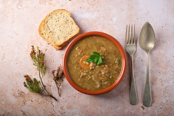 Lentil Casserole Served in a Bowl With Bread and Utensils on a Table
