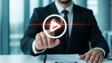 Businessman's finger points to a glowing play button, symbolizing video, media, and digital content.