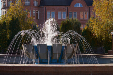 A fountain styled like a ball-shaped drill bit, with multiple water jets against the backdrop of a building.
