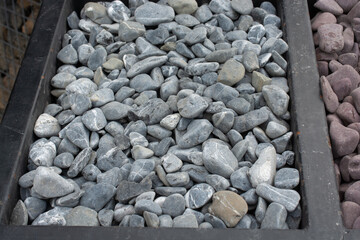 Smooth garden pebbles texture with dark border background