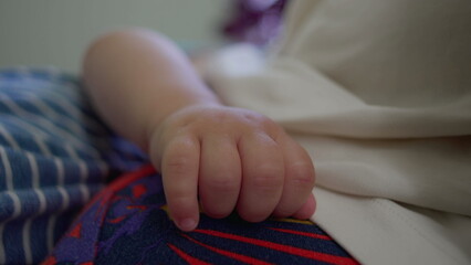 Close up of baby hand resting on mother’s body, soft skin and relaxed posture in intimate home...