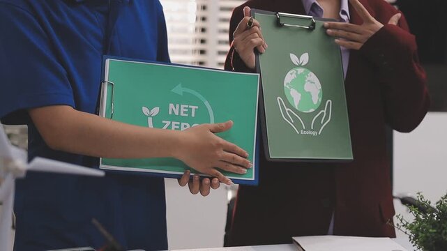 Close up of business people shaking hands over ESG strategic commitment workshop, SDGs report, global warming, green finance investment eco friendly and net zero waste in boardroom training building.