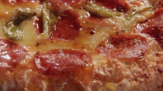 Dolly move sliding overtop overhead greasy unhealthy frozen round pizza pizzas home cooked meal for American families with big bread crusts, marinara sauce, meats, herbs, and lens flare in slow motion