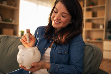 Woman saving money in piggy bank for future planning
