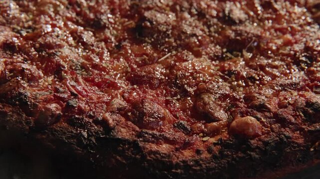 Dolly move sliding overtop overhead greasy unhealthy frozen round pizza pizzas home cooked meal for American families with big bread crusts, marinara sauce, meats, herbs, and lens flare in slow motion