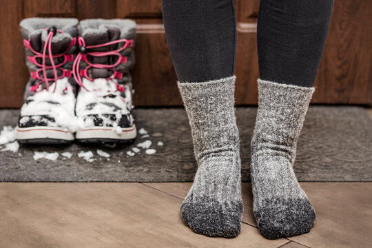 Frozen Feet and Wet Socks due Bad Waterproof Snow Boots. Cold Feet in Child in Winter.