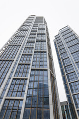 Obraz premium Modern Glass Skyscraper Exterior Low Angle View