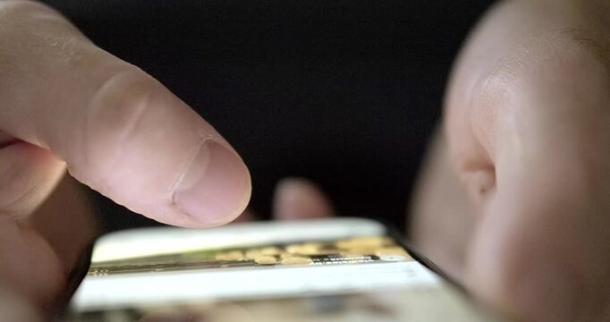 Man flipping through mobile phone. High quality 4k footage