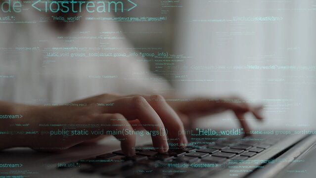 A focused individual types on a laptop keyboard, surrounded by digital code and data, representing modern programming and technology in a dynamic workspace setting. Xenic