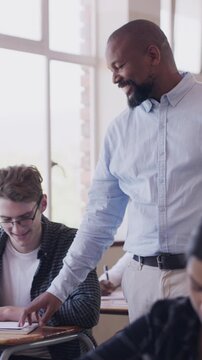Man, teacher and students writing in class for education, monitor exam and supervision. Mature educator, walk and children with school assessment, invigilation and maintain order to prevent cheating