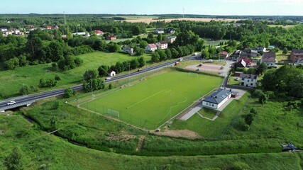 Soccer field watering with automated sprayer in summer