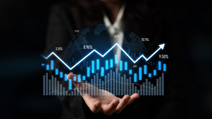 A business professional displays digital financial graphs and analytics in a dark setting, showcasing growth, trends, and opportunities in modern commerce. Scalp