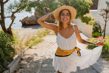 young attractive blond woman in summer style white dress and straw hat smiling having fun at the beach © mary_markevich