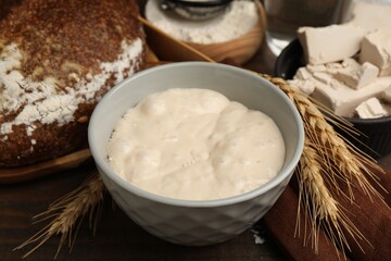 Yeast dough and ingredients on wooden table, closeup