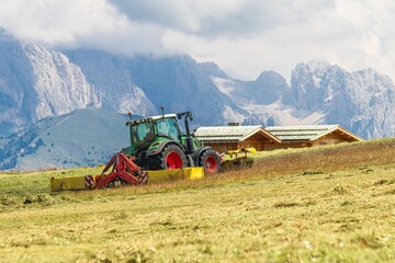 Tractor with combined mower in alpine hayfield