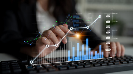 A business professional analyzes financial data using keyboard with modern graphs and charts overlaid, showcasing insights in a contemporary office environment. Scalp