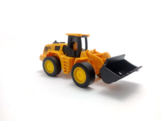 A yellow toy tractor with a front loader is displayed on a white background.