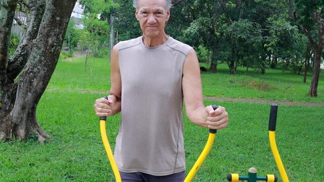Slow Motion of an Older Man working out at an Outdoor Fitness Gym