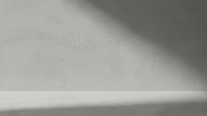 a textured gray wall illuminated by a bright angled light beam in a minimalistic space