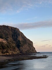 Fototapeta premium Sunset Over a Rocky Coastline by the Sea