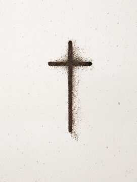Cross made of ash on white background representing Ash Wednesday  