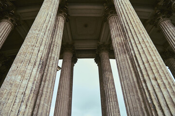 Fototapeta premium Majestic ancient colonnade viewed from ground level under overcast sky