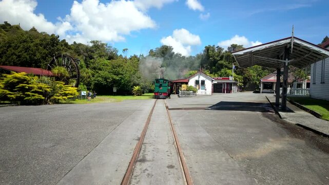 Walking Along Tracks Toward Steam Train Station