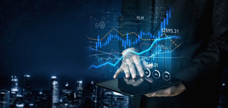 A professional businessman analyzes financial data on a digital tablet featuring stock market graphs and charts, with a stunning night cityscape in the background. Scalp - Powered by Adobe