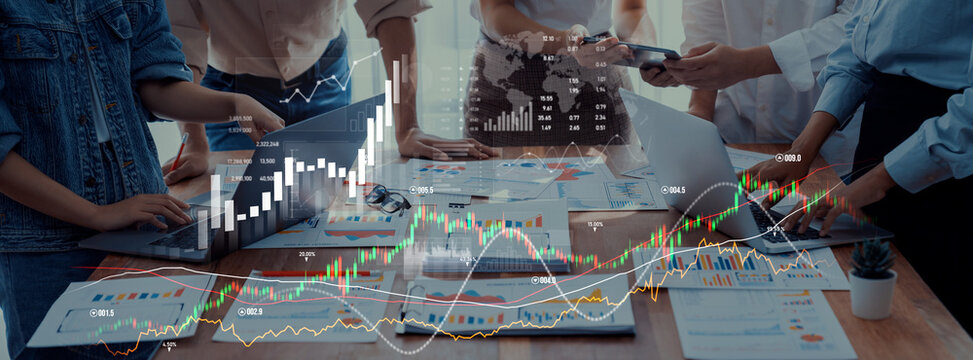 A diverse team collaborates in a modern office setting, analyzing financial data on screens and documents, showcasing teamwork and strategic planning for business success. Scalp