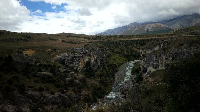 Mountain Gorge View With River And Dramatic Clouds