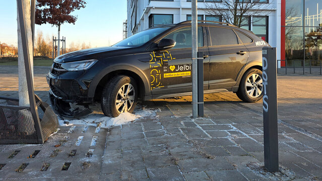 Damaged Jelbi carsharing Volkswagen vehicle parked on a sidewalk in Berlin, Germany, January 19, 2026