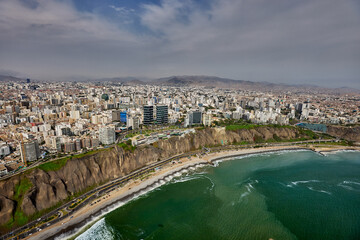 Fototapeta premium aerial perspective captures the vibrant essence of Miraflores and the iconic Costa Verde during the height of a Peruvian summer. From this vantage point, you can see where the modern urban landscape 