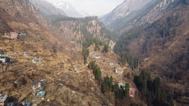 Aerial view of Tosh village nestled in Parvati Valley also cover Panoramic view of Tosh village at sunset, scenic mountains and pine forests in Kullu district, India.