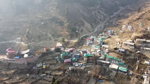 Aerial view of Tosh village nestled in Parvati Valley also cover Panoramic view of Tosh village at sunset, scenic mountains and pine forests in Kullu district, India.