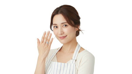 Fototapeta premium Portrait of a charming young Asian woman in an apron waving her hand with a gentle smile.
