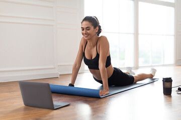 Stay Fit. Smiling Young Woman In Sportswear Practicing Pilates At Home With Laptop, Watching Online...