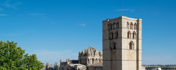 Stone church tower of zamora cathedral viewed from jardines de baltasar lobo park in zamora