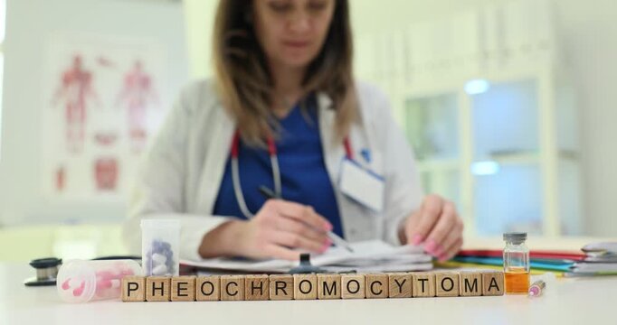 Wooden cubes spell word Pheochromocytoma near organ model and syringe. Woman doctor writes report controlling blood pressure crisis treatment plan