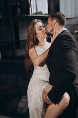 Couple shares kiss in stylish indoor setting during special moment