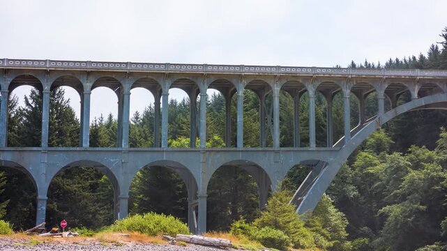 A view of the iconic Cape Creek Bridge, an architectural marvel resembling a Roman aqueduct, located on the scenic Highway 101 near Florence, Oregon.