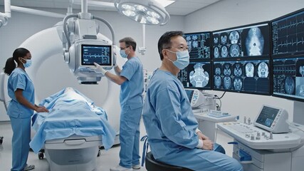 Medical team collaborating in advanced imaging room, adjusting equipment and analyzing patient data on multiple screens for precise diagnostics - Powered by Adobe