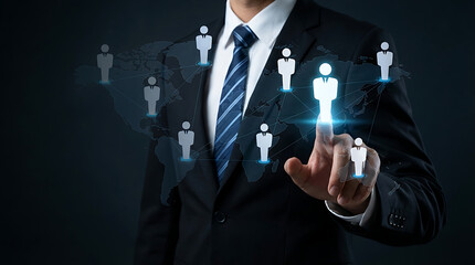 Professional businessman selecting global talent on virtual world map with human icons representing international recruitment and networking for remote workforce management solutions