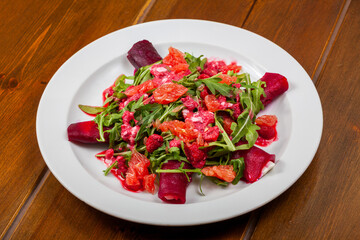 a plate full of red salad