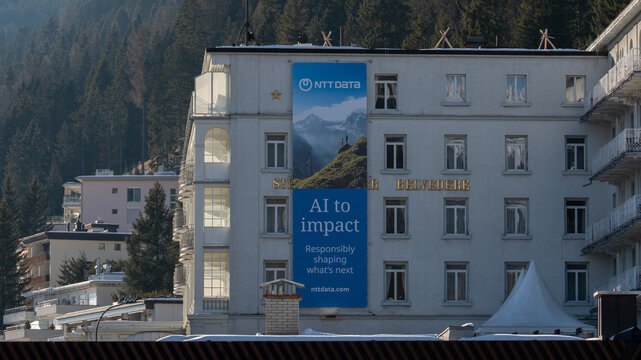 Davos, switzerland, january 20th 2026 hotel belvedere building displaying ai impact banner in davos