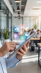 Obraz premium Smart Workplace with High-Tech Device: A person uses a tablet device to interact with the modern office's cloud-based icons. Focus on work and the technologies. 
