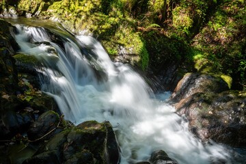 Obraz premium Long exposure of a waterfall on the Hoar Oak Water river at Watersmeet in Exmoor National Park