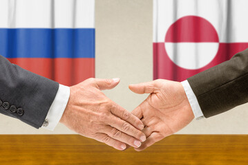 Symbolic cooperation concept &ndash; Russia and Greenland handshake