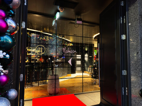 Bar and grill Malmaison entrance in Manchester with festive decorations and glass doors