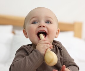 Cute little baby with teether at home