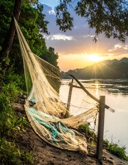 Fishing Net on Riverbank at Sunset - A Serene Scene.
